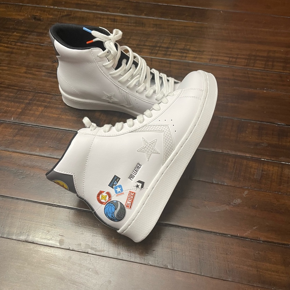 White High-Top leather converse with busy of color sports enthusiast logos .